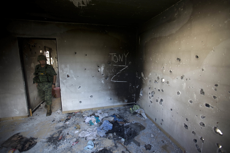 A soldier enters a bullet-riddled home in 2014 that is tagged with the initials CDG for the Gulf Cartel, and Z for Zetas, in Ciudad Victoria, in Mexico&#039;s state of Tamaulipas. One law enforcement official in the northern border state says he routinely sees young cartel gunmen who see killing as the best professional path they can take.