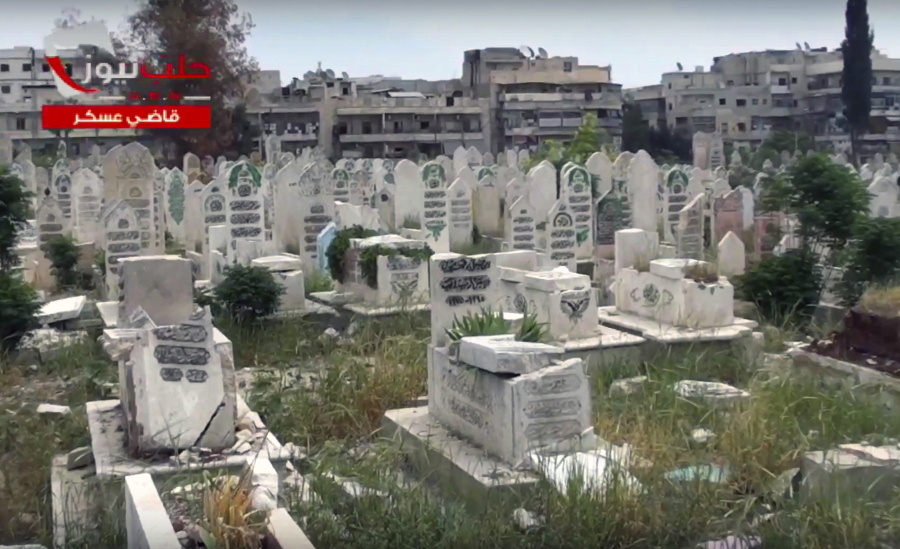 This frame grab from video provided Oct. 17 by the Aleppo News Network shows men standing in an graveyard during a burial ceremony in eastern Aleppo city, in Syria. The old Aleppo cemetery filled up a year ago, the new one filled up this week, and now the dead are left in the besieged enclave&#039;s streets, buried in backyards and overwhelming the morgues. Dignity in death has been lost as the rebel-held enclave of eastern Aleppo that held out for four years collapses.