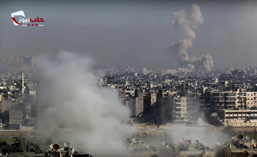 This frame grab from video provided by the Aleppo News Network shows smoke rising following an airstrike Friday that hit insurgents positions in eastern neighborhoods of Aleppo, Syria. Hundreds of Syrian civilians streamed out on foot from the eastern part of the city of Aleppo on Friday in the wake of the relentless campaign by government troops and their allies to drive rebels from their rapidly crumbling enclave.