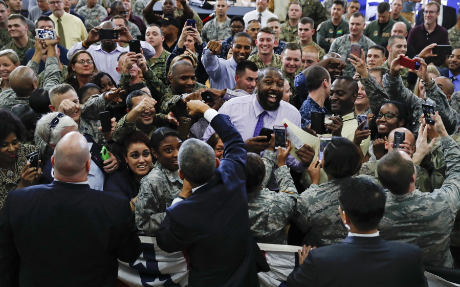 President Barack Obama, center front, reaches over to fist-bump service members Tuesday at MacDill Air Force Base in Tampa, Fla.