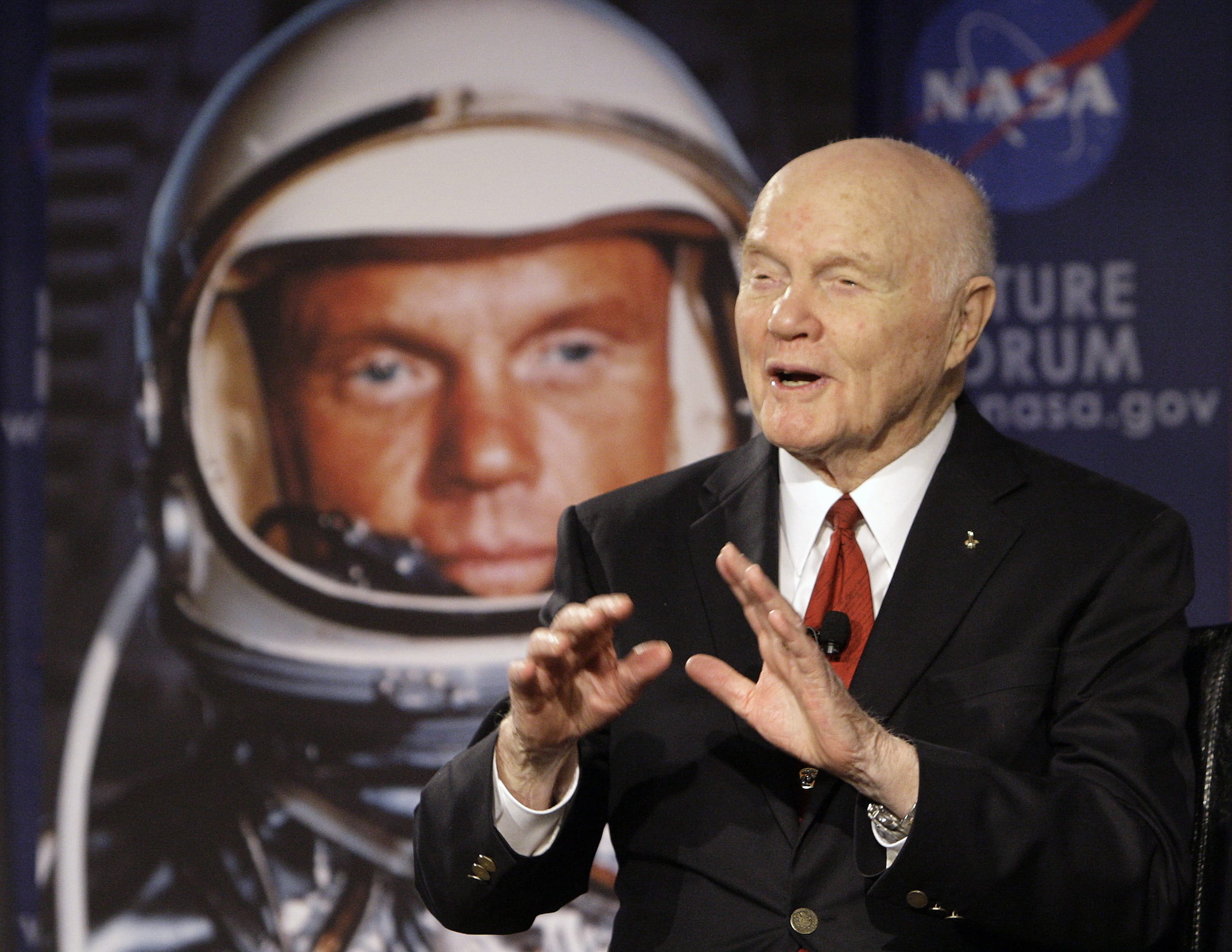 U.S. Sen. John Glenn talks with astronauts on the International Space Station via satellite Feb. 20, 2012 before a discussion titled "Learning from the Past to Innovate for the Future" in Columbus, Ohio. Glenn, who was the first U.S. astronaut to orbit Earth and later spent 24 years representing Ohio in the Senate, has died at 95.