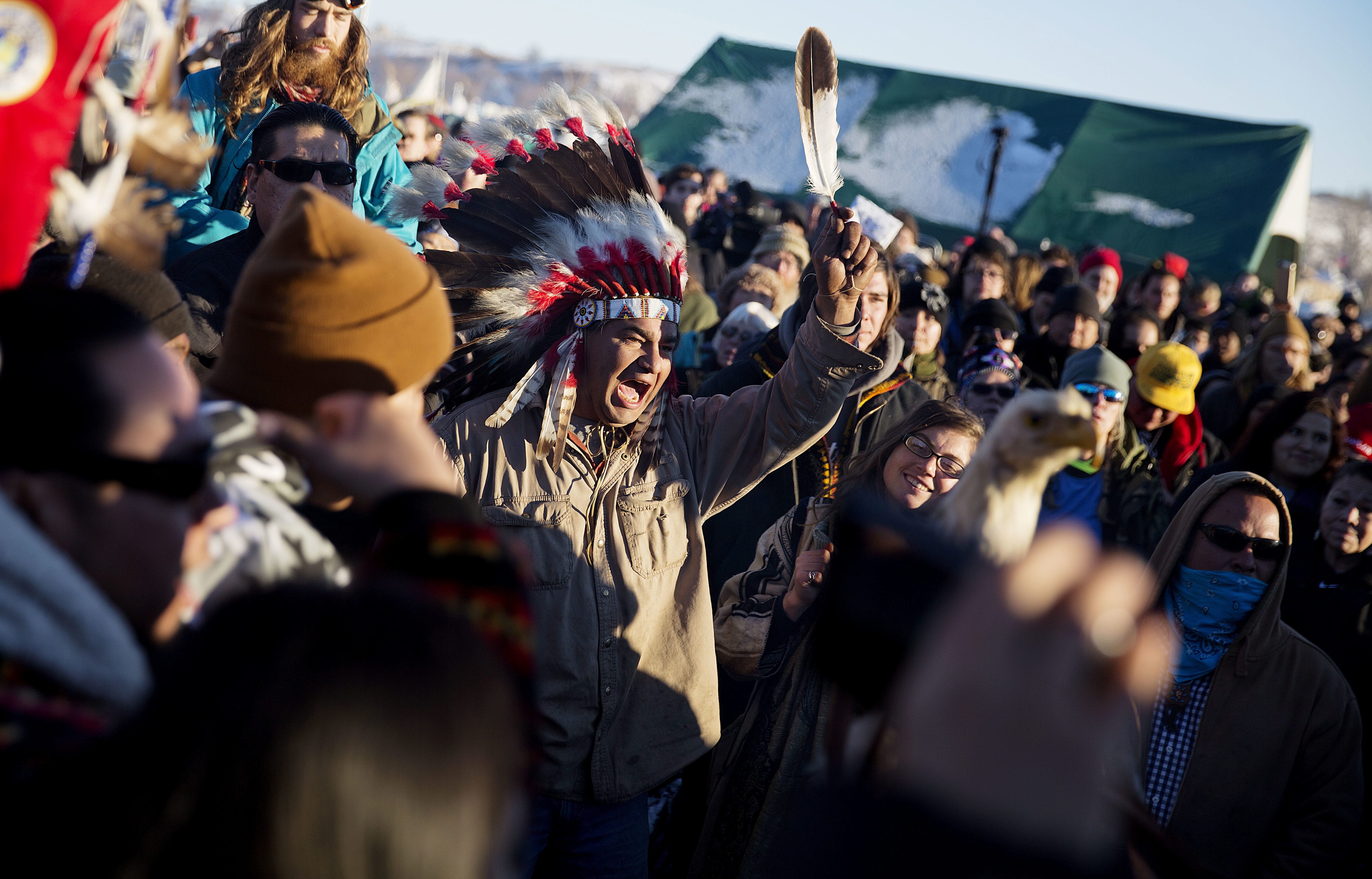 A crowd gathers in celebration at the Oceti Sakowin camp after it was announced that the U.S. Army Corps of Engineers won't grant easement for the Dakota Access oil pipeline in Cannon Ball, N.D., Sunday, Dec. 4, 2016.
