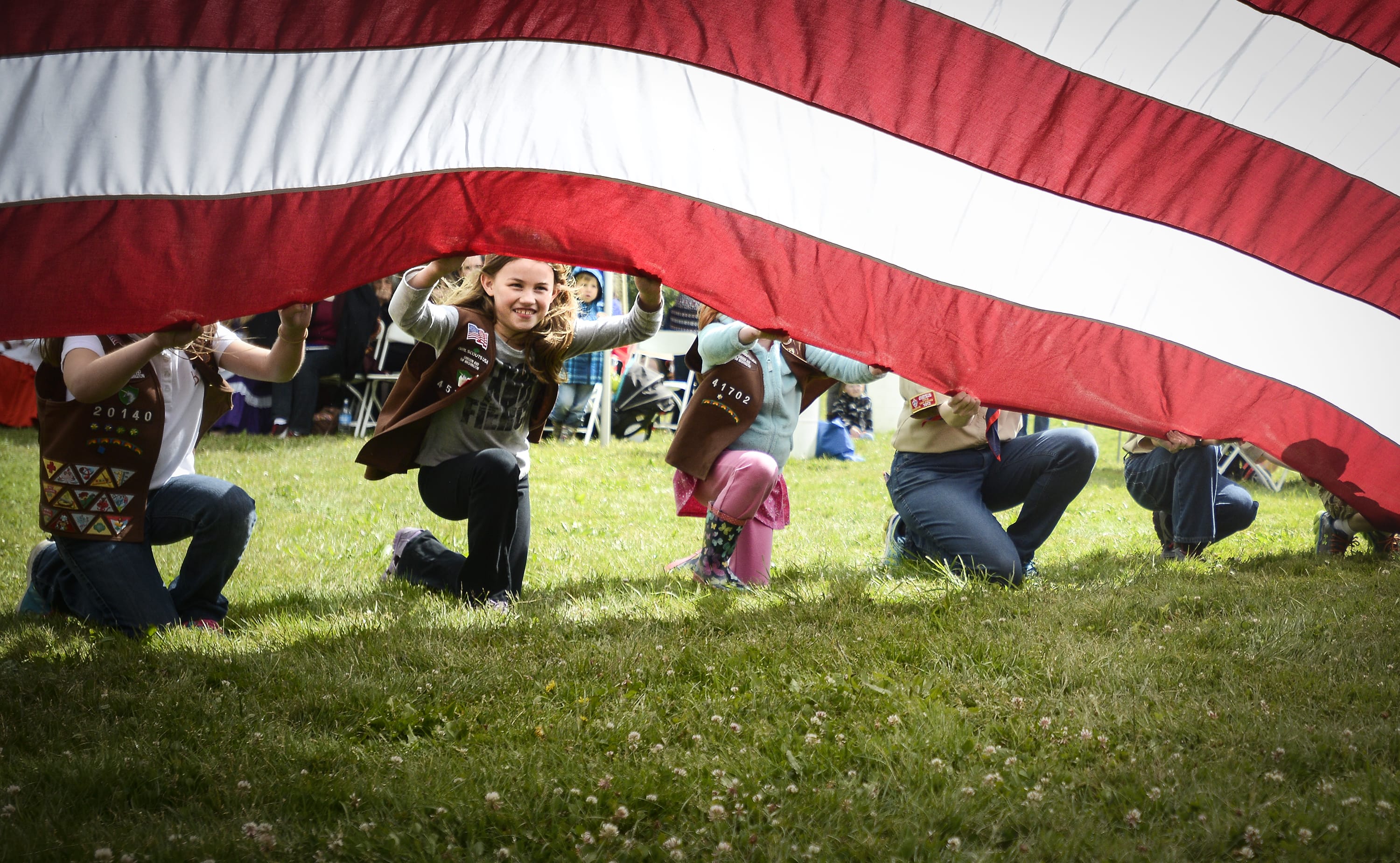 Mikaela Fisher, a member of Brownie Girl Scout Troop #45722, helps hold a flag at Fort Vancouver during the Flag Day celebration, Tuesday June 14, 2016.