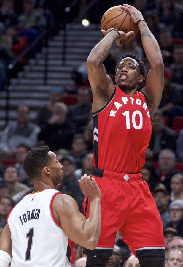 Toronto Raptors guard DeMar DeRozan, right, shoots over over Portland Trail Blazers guard Evan Turner during the first half of an NBA basketball game in Portland, Ore., Monday, Dec. 26, 2016.