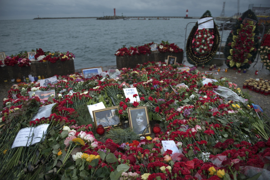 Flowers, candles and portraits are placed at a pier in honour of the victims of the military plane crash, in Sochi, Russia, in Sochi, Russia, on Wednesday. All 84 passengers and eight crew members on the Russian military&#039;s Tu-154 plane are believed to have died Sunday morning when it crashed two minutes after taking off from the southern Russian city of Sochi.