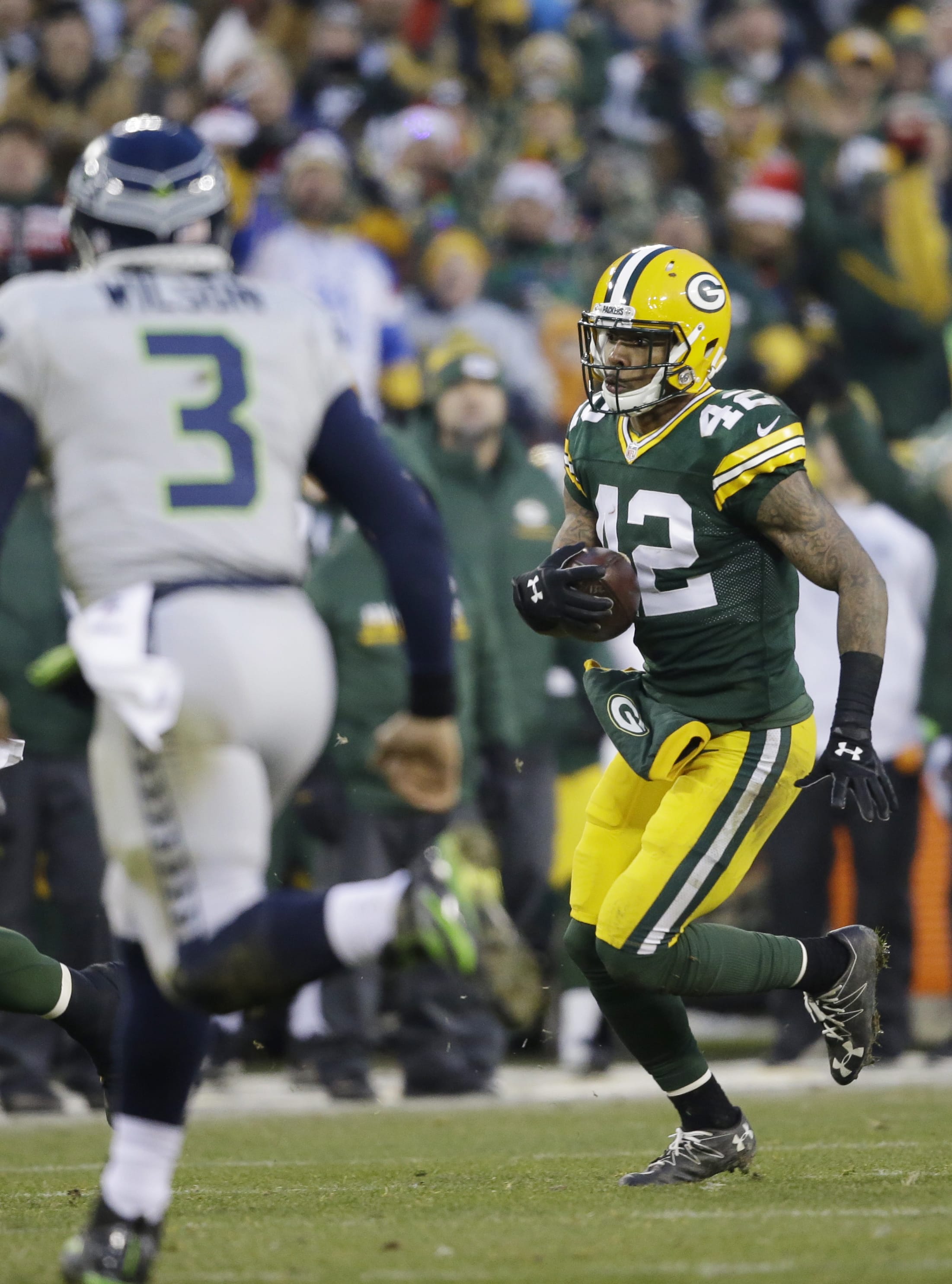 Green Bay Packers' Morgan Burnett runs back his interception during the first half of an NFL football game against the Seattle Seahawks Sunday, Dec. 11, 2016, in Green Bay, Wis.