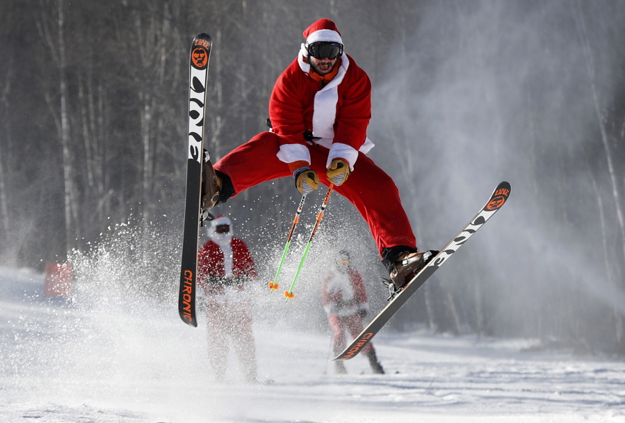 A skier dressed as Santa Claus catches some air during the annual Santa Sunday charity run, Sunday, Dec. 4, 2016, at the Sunday River ski resort in Newry, Maine. Santa Sunday raises money for the Sunday River Community Fund, a local charity. (AP Photo/Robert F. Bukaty) (Robert F.