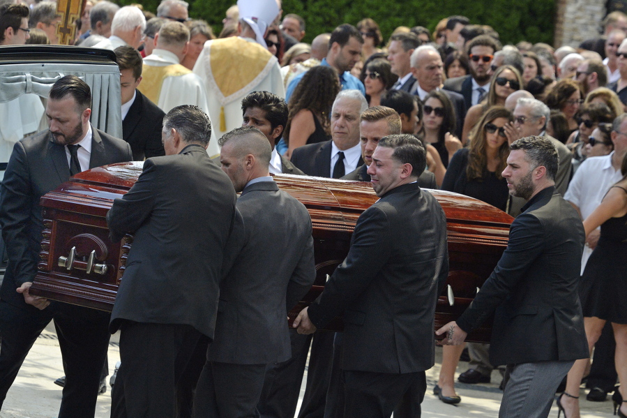 FILE - In this Aug. 6, 2016 file photo, mourners carry the casket of Karina Vetrano from St. Helen&#039;s Church following her funeral in the Howard Beach section of the Queens borough of New York. With a DNA profile, but no name to match it in the search for her killer, prosecutors are now seeking permission to try an emerging approach: using the DNA to search for the killer&#039;s relatives.