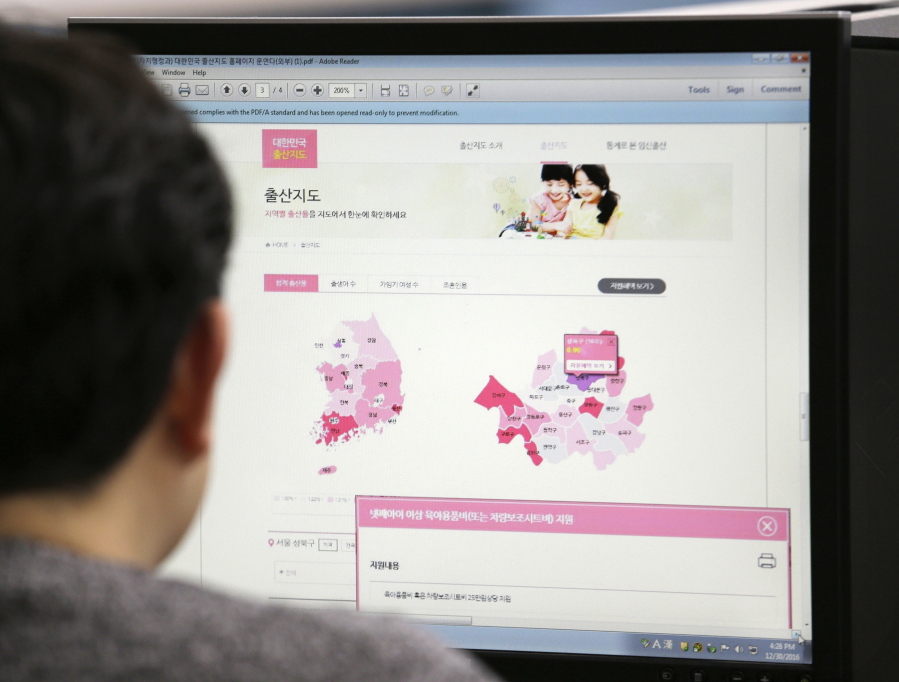 A journalist watches a screen showing a press release from the South Korean Ministry of the Interior about the birth map showing the number of women in childbearing age at his office in Seoul, South Korea, Friday, Dec. 30, 2016. South Korea&#039;s government closed its website that drew fury for showing the number of women in childbearing age by each city district and region.