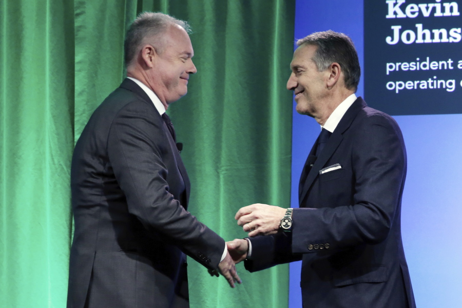 Starbucks Chairman and CEO Howard Schultz, right, introduces company president and COO Kevin Johnson at the Starbucks 2016 Investor Day meeting Wednesday.