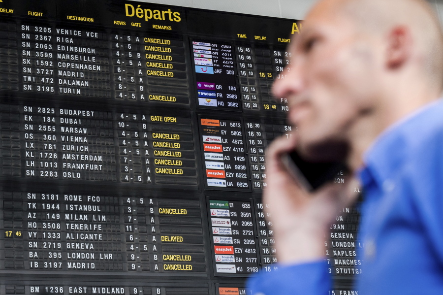 A passenger makes a phone call as he walks by a flight information board at Brussels Airport in Zaventem, Belgium. You don&#039;t have to pay a fortune to use your phone abroad, but you need to plan ahead. Getting a local plan when you arrive is the most economical choice, but it&#039;s not practical for many people.