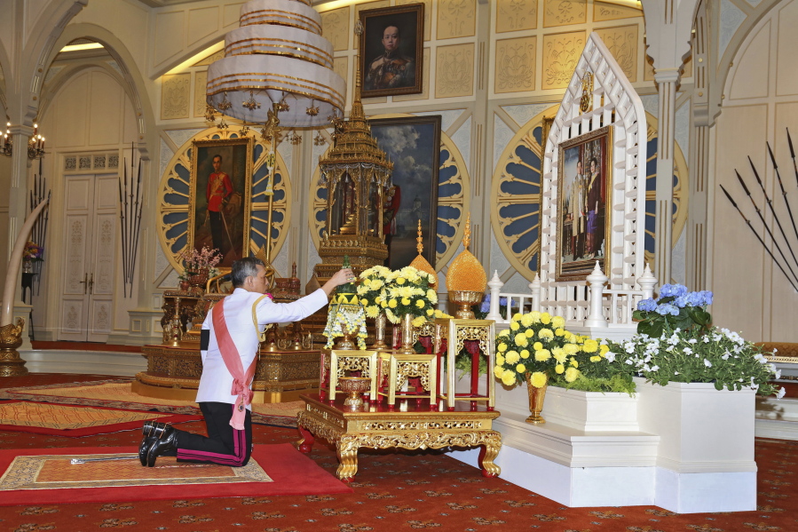 Thailand&#039;s new king, Maha Vajiralongkorn Bodindradebay-avarangkun, pays his respects to a portrait of his late father, King Bhumibol Adulyadej, and Queen Sirikit on Thursday at the Dusit Palace Bangkok.