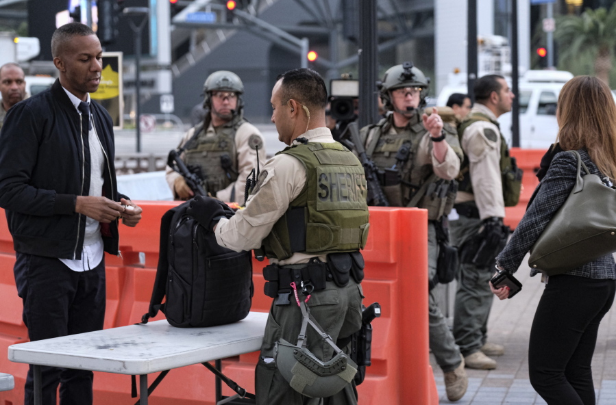 A commuter has his bag checked Tuesday by a Los Angeles County sheriff&#039;s deputy at the Universal City Red Line station in Los Angeles. Heavily armed sheriff&#039;s deputies are guarding the station and other parts of Los Angeles County&#039;s transit system following a threat, which the FBI says specified the attack would occur Tuesday.