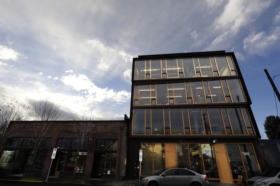This Nov. 15, 2016, photo shows Lever Architecture headquarters, a four-story all-wood building built using cross-laminated timber, or CLT, in Portland, Ore. CLT is made up of 2-by-4 beams laid out in perpendicular layers that are then glued together to make giant panels.