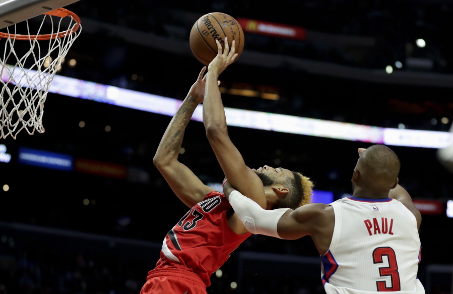 LA Clippers guard Chris Paul, right, fouls Portland Trail Blazers guard Allen Crabbe during the second half of an NBA basketball game in Los Angeles, Monday, Dec. 12, 2016. The Clippers won 121-120.
