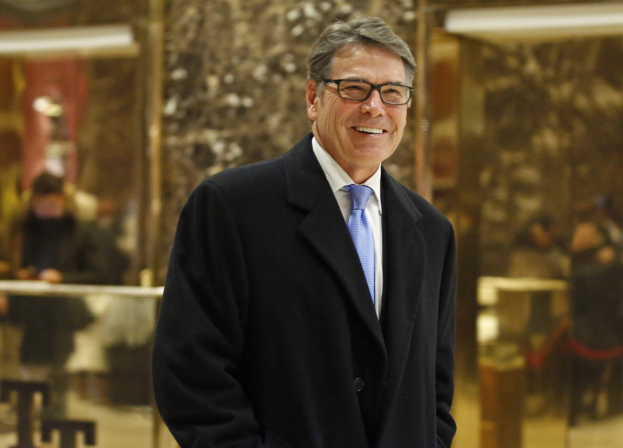 Former Texas Gov. Rick Perry smiles as he leaves Trump Tower in New York. Perry is President-elect Donald Trump???s choice to become energy secretary, two people with knowledge of the decision say.