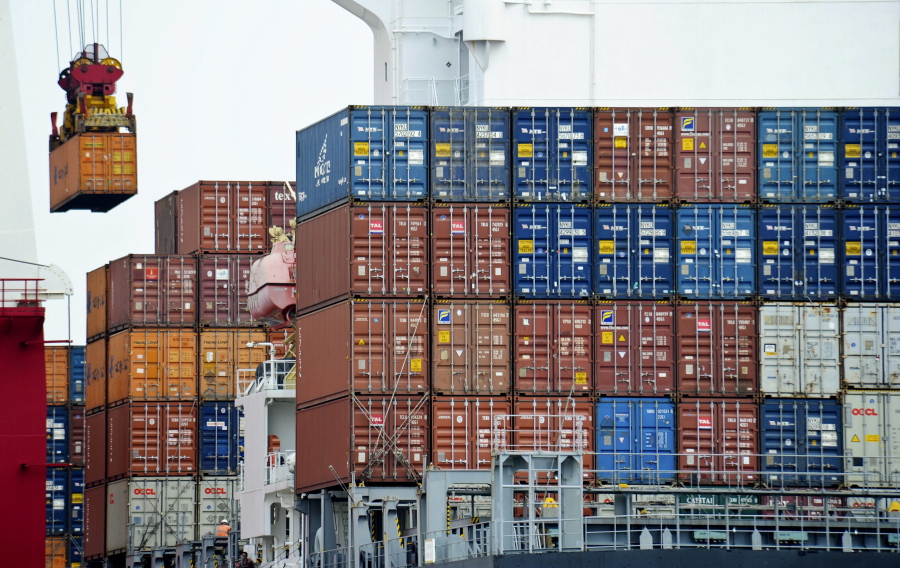 A container is loaded onto a cargo ship Aug. 5, 2010 at the Tianjin port in China. American consumers and businesses would pay, literally, if President-elect Donald Trump follows through on his campaign pledge to slap big taxes on imports from China and Mexico.