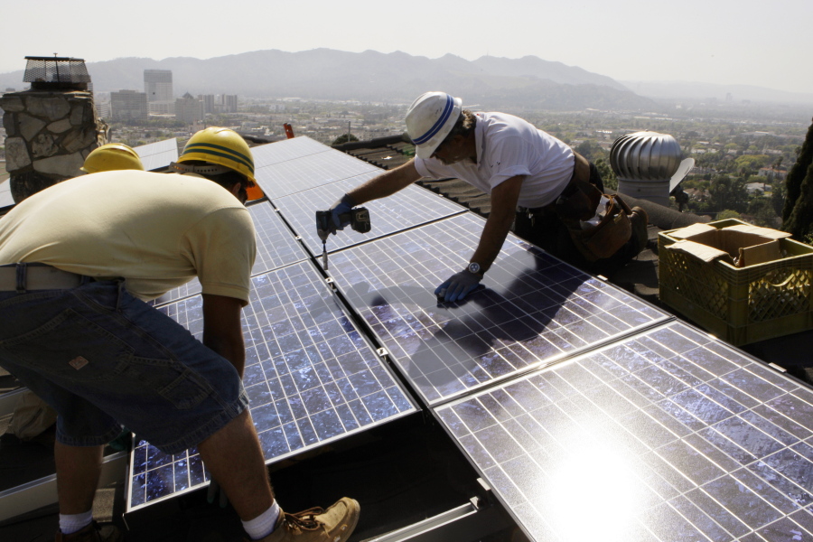 Installers from California Green Design install solar electrical panels on the roof of a home in Glendale, Calif. Renewable energy developers say they&#039;re hopeful about the future despite President-elect Donald Trump&#039;s promise to bring coal mining jobs back. In recent years, huge solar and wind farms have sprouted up on public desert land in the Western United States buoyed by generous federal tax credits.