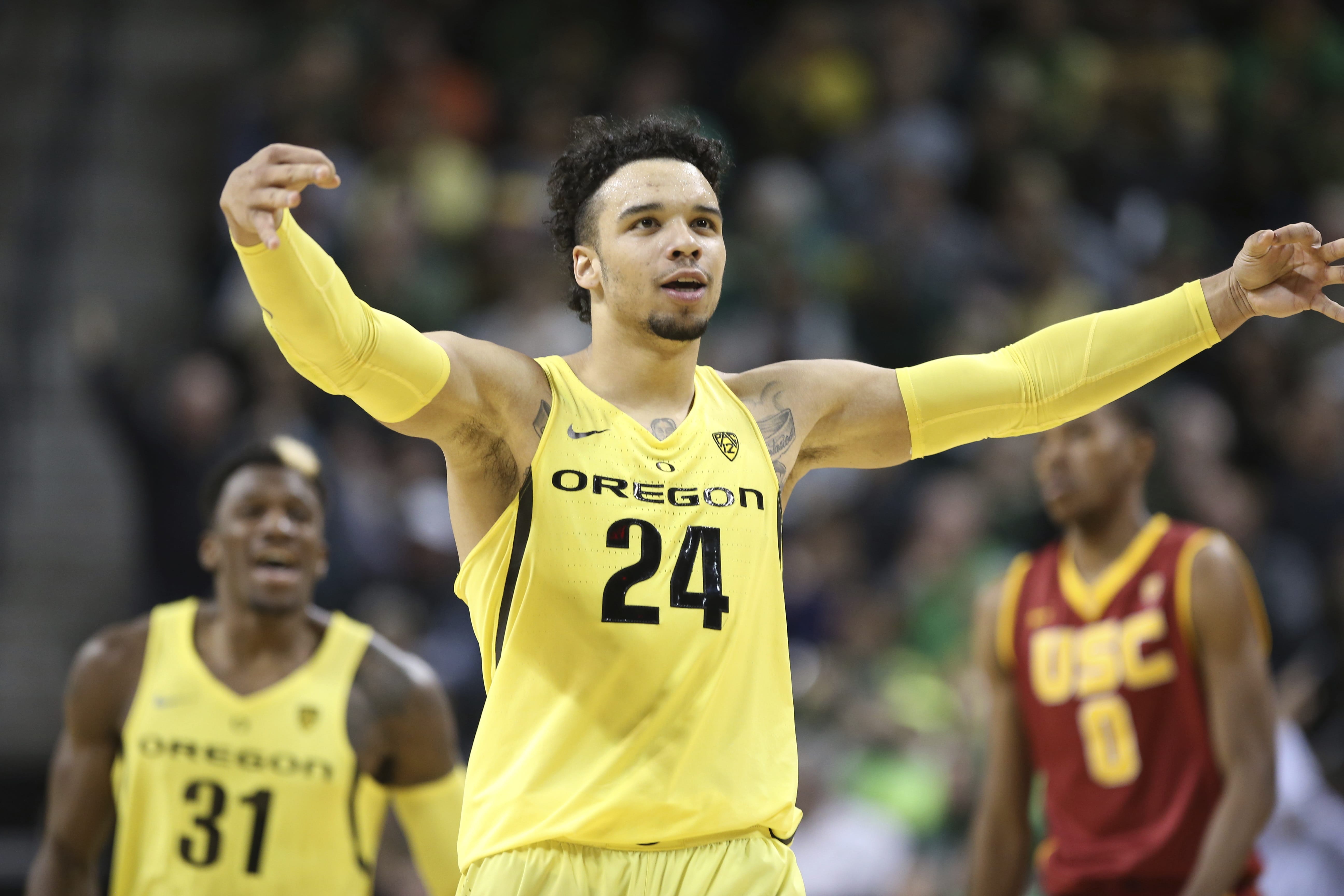 Oregon's Dillon Brooks, center, celebrates after scoring against Southern California during the second half of an NCAA college basketball game Friday, Dec. 30, 2016, in Eugene, Ore.