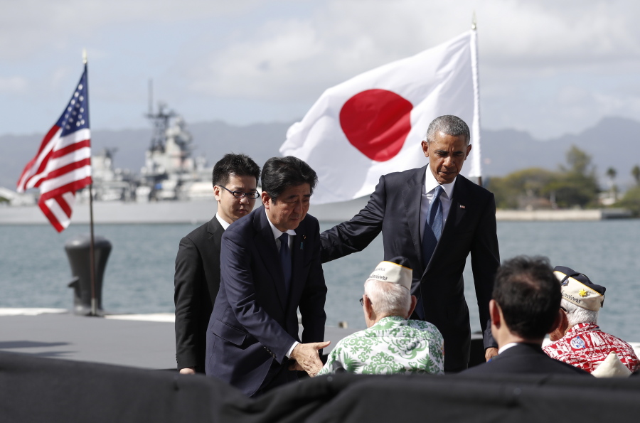 Japanese Prime Minister Shinzo Abe and President Barack Obama greet  survivors of the Dec. 7, 1941, attack Tuesday on Kilo Pier overlooking the USS Arizona Memorial at Pearl Harbor, Hawaii.