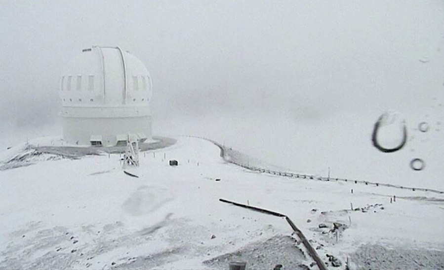 In this image made from webcam video provided by Canada-France-Hawaii Telescope, the CFHT telescope on the summit of Mauna Kea on Hawaii&#039;s Big Island is surrounded by snow Thursday.