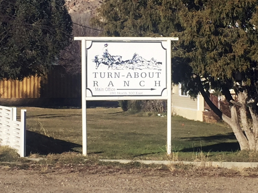 This Tuesday, Dec. 6, 2016 photo shows a sign for Turn-About Ranch in Escalante, Utah. A teenager accused of killing a staff member at the youth treatment center and injuring another worker carried out the attacks because he wanted to leave the ranch, not because of a grudge against either person, a Utah sheriff said Wednesday, Dec. 7.