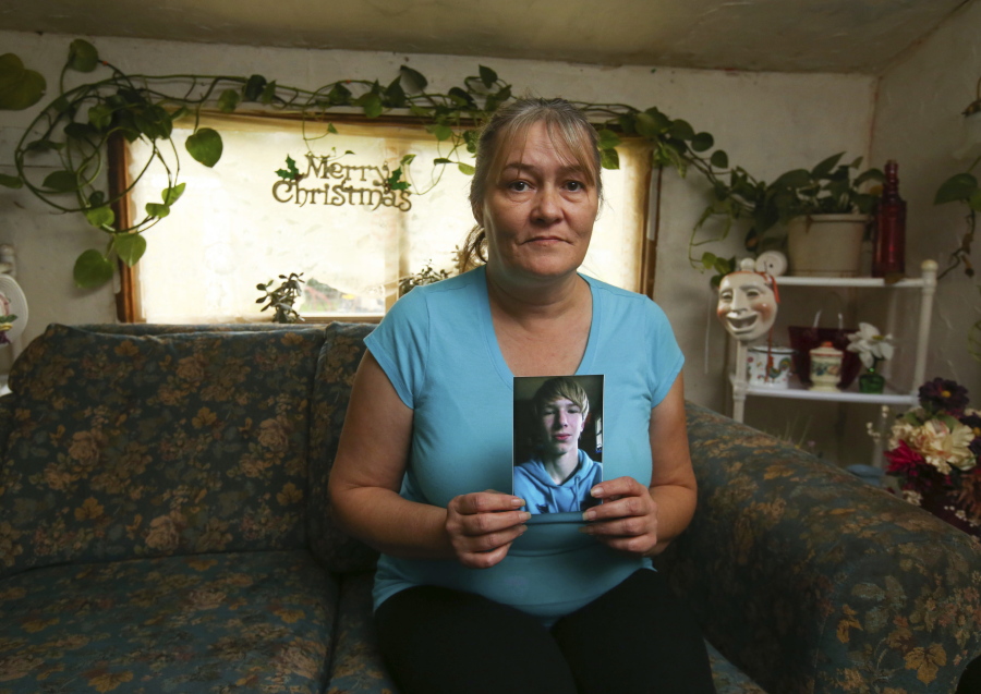 Jamie Heizelman shows a photo  of her 15-year-old grandson Brandon Kimble on Wednesday in her Mapleton, Ore., home. Brandon killed himself last week.