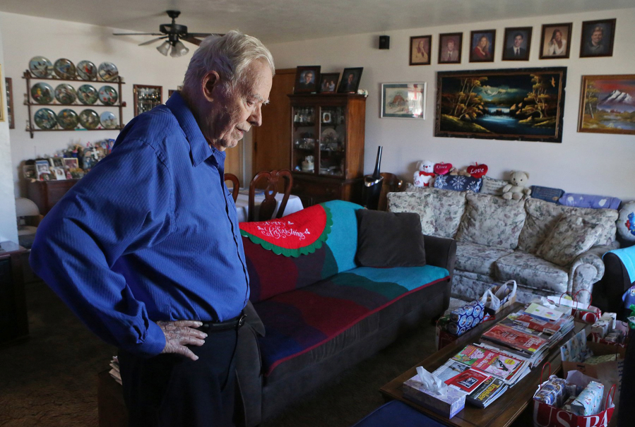 Bob King, 87, talks about how he and his wife, Donamay, raised six kids in their small home that they have lived in for more than 50 years on Dec. 22 at his home in Kirkwood, Mo. The six children&#039;s portraits are on the opposite wall. (Photos by J.B. Forbes/St.
