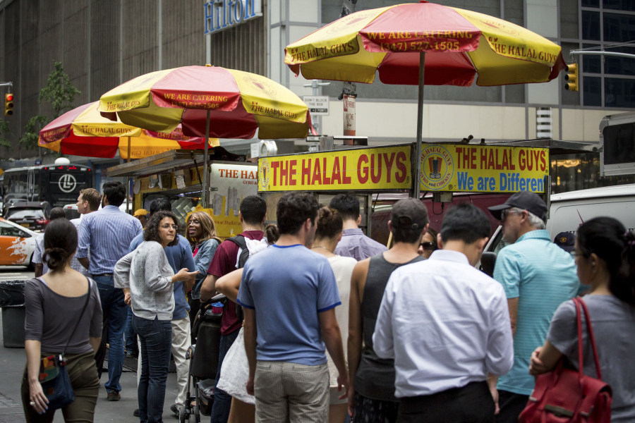 Customers stand in line at The Halal Guys&#039; food cart Sept. 9 in New York.