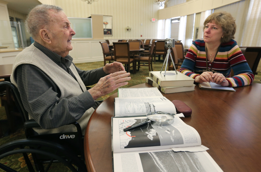 World War II veteran Clyde Dye, 93, is interviewed by Suzanne Nichols, a Summa volunteer, at a hospice center in Akron, Ohio, in December. Nichols is working on a history project for The Library of Congress.