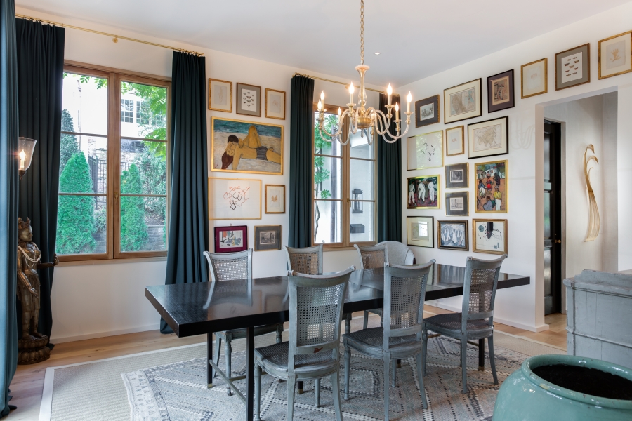 The dining room of designer Ally Banks and builder Michael Banks in Washington, D.C., features an interesting gallery wall with different types of artwork.