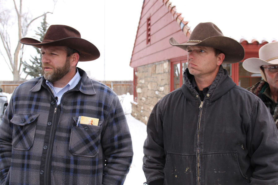 Ammon Bundy, left, and Ryan Bundy stand in the snow last year during the standoff at the Malheur National Wildlife Refuge in Oregon.