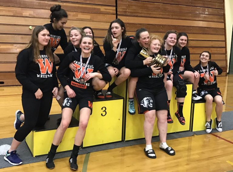The Washougal girls wrestling team celebrates its first-place finish at the Clark County Wrestling Championships at Hudson’s Bay High School on Saturday.