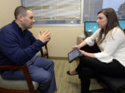 Dr. Jason Dranove discusses cancer treatment guidelines with genetic counselor Stacy Lenarcic at Carolinas HealthCare System&#039;s Levine Cancer Institute on Dec. 13 in Charlotte, N.C. Dranove, a doctor at Levine Children&#039;s Hospital, had breast tissue removed to prevent cancer that killed his uncle. (David T.