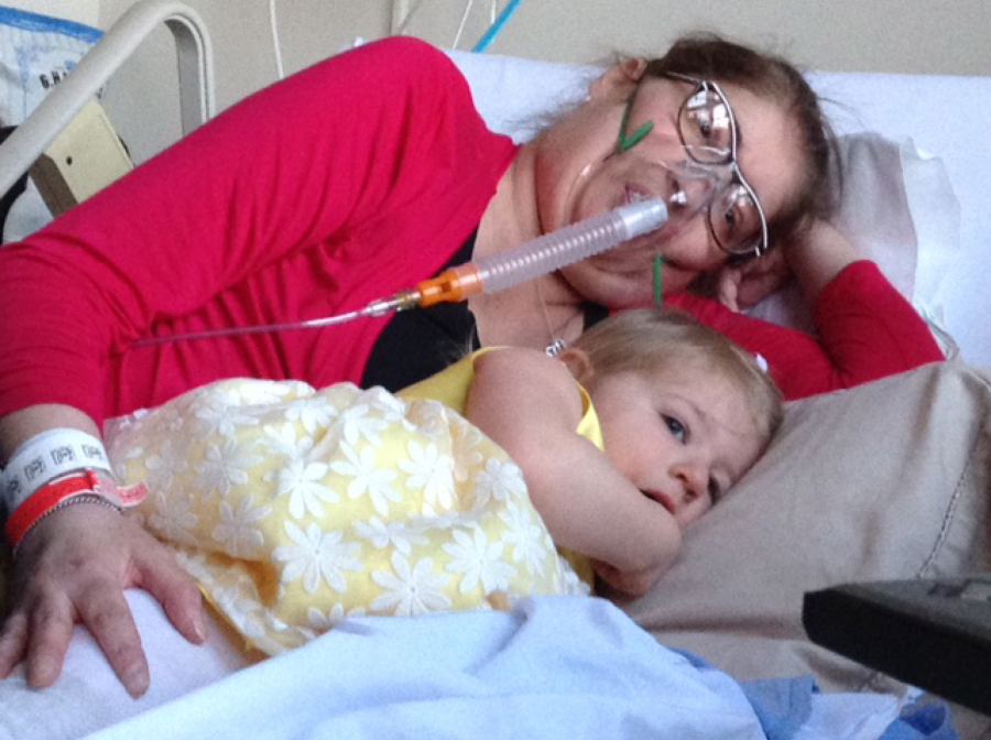 Melissa Benoit snuggles with her daughter, Olivia, before receiving a double lung transplant.