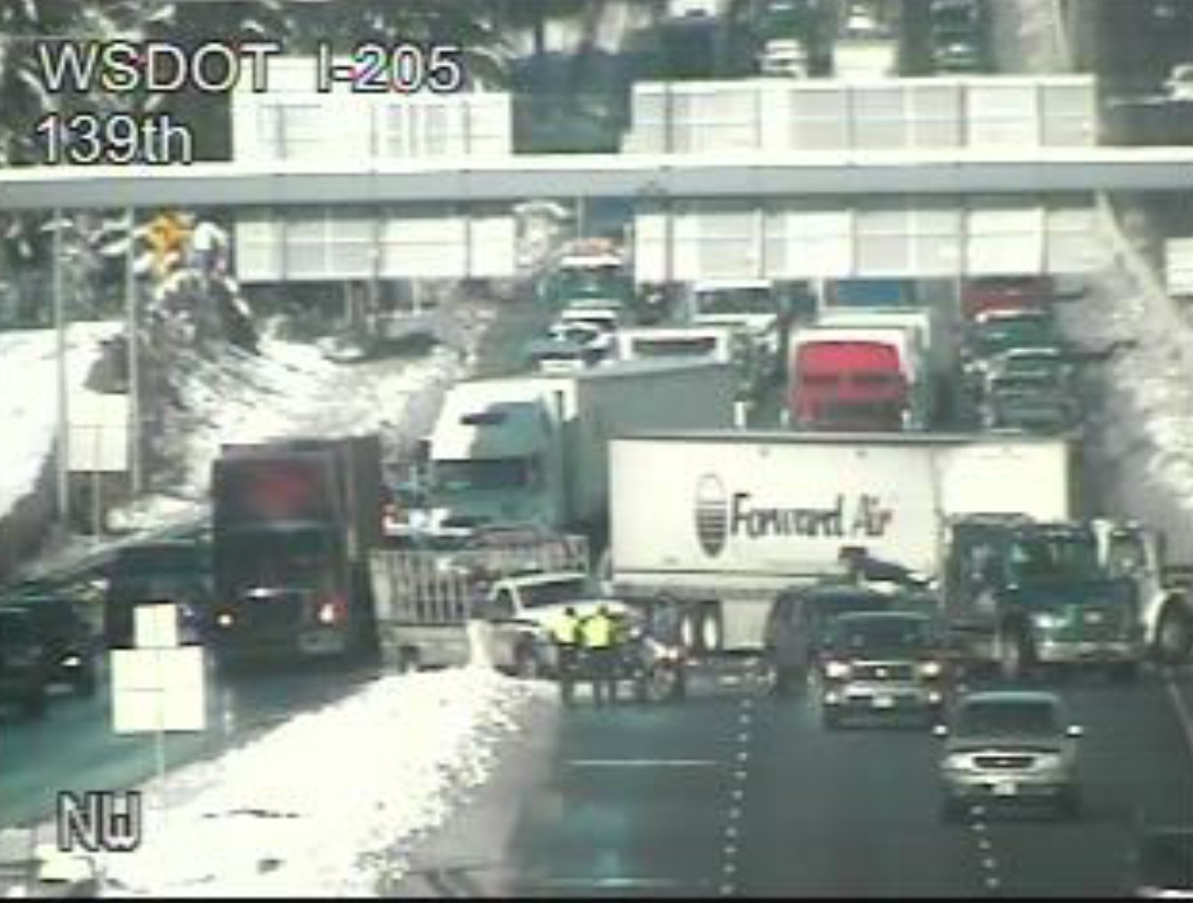 A jackknifed tractor-trailer blocks most of southbound Interstate 5 near its split with Interstate 205 after noon Thursday. Traffic was squeaking by in one lane.