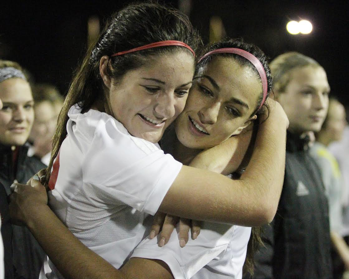 Camas Papermakers' Alyssa Tomasini, left, is hugged by teammate Maddie Kemp after Tomasini booted in the winning goal against the Skyline Spartans' in the WIAA 4A Semifinal Women's soccer match held Friday, November 18, 2016 at  Sparks Stadium in Puyallup, WA. The Papermakers beat the Spartans 1-0 to advance to the championship match which will be held at 4 PM at Sparks Stadium in Puyallup.