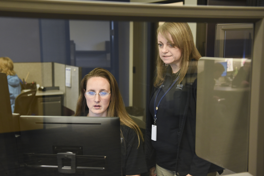 Police records specialist Sara Cox works with records supervisor Gail Truax at the Vancouver Police Department&#039;s West Precinct in the new records office last month.