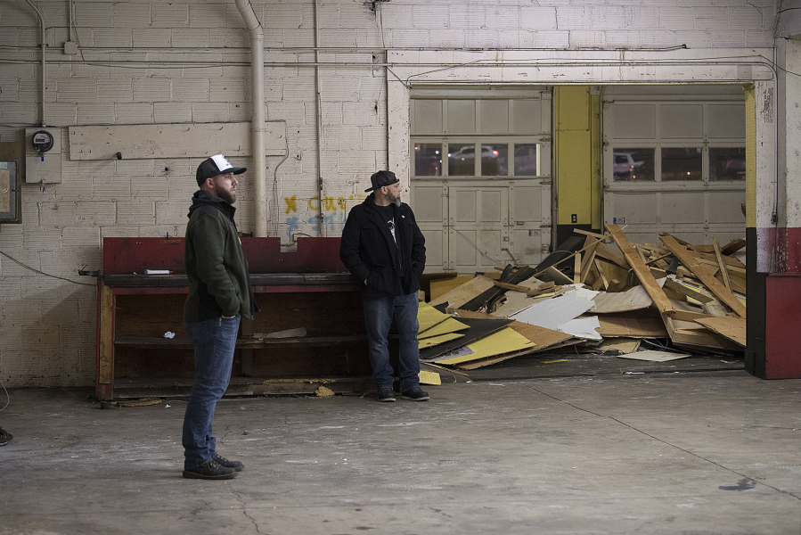 Co-owners Brendan Greenen, left, and Mike Hunsaker look over the former Lemon-Aid Automotive warehouse, which they are in the process of turning into Grains of Wrath.