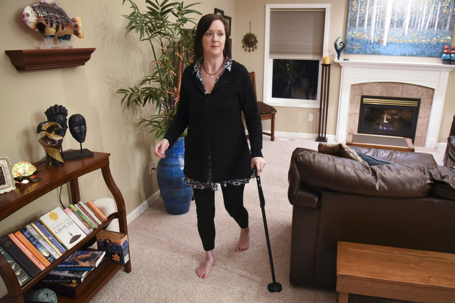 Debra Weidner, who has multiple sclerosis, uses a cane to move around her home in Camas. Weidner is traveling to Mexico in March for a hematopoietic stem cell transplant to treat her MS.