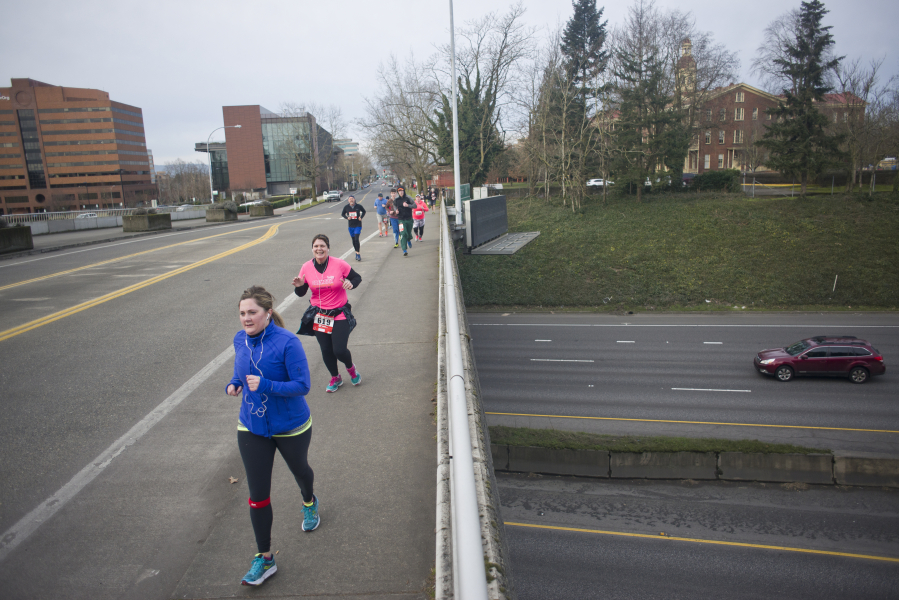 Runners make their way along the annual Race for Warmth route Sunday morning in Vancouver.