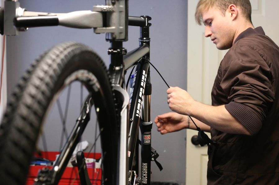 Wes Foster works on one of the many bicycles built by Volcanic Bikes. The North Bonneville-based company supplies heavy-duty bicycles to police departments such as those in Seattle, Washington, D.C., and Los Angeles.