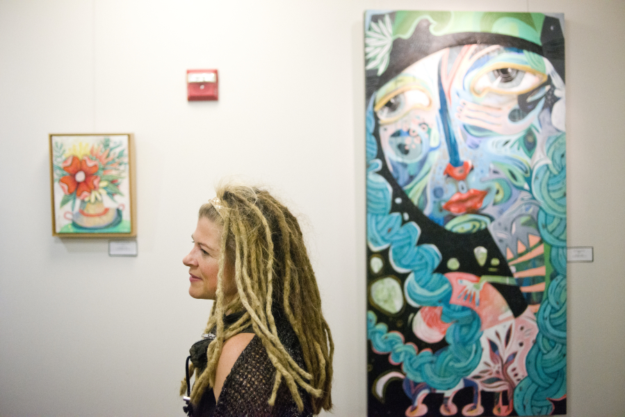 Vancouver artist Michelle Allen discusses her paintings during the Dec. 9 rededication of the sixth-floor art gallery in the Clark County Public Service Center as the Anstine Gallery.