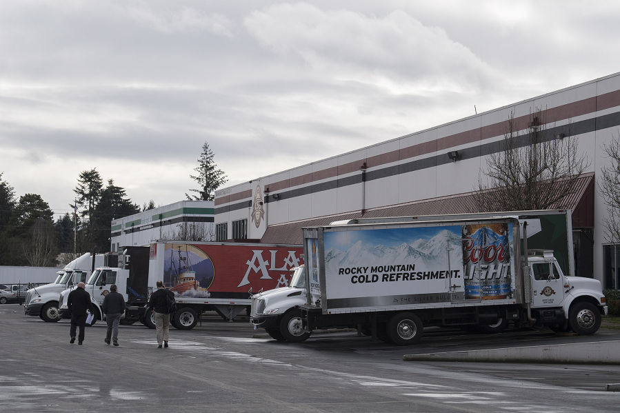 Trucks line up outside of Craig Stein Beverage on Thursday. The Clark County beverage distributor plans to grow by merging with a similar company based in Bellevue and purchasing another distributor in Washington.