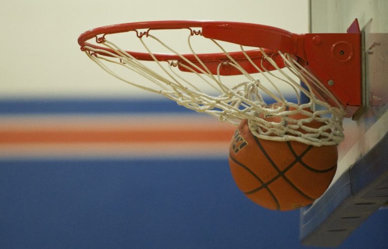 The basketball rips the net at Ridgefield High School.