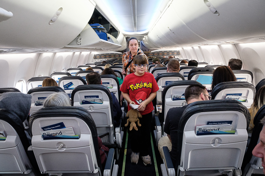 A Vancouver family boards a plane during an event hosted by the Autism Society of Oregon and Alaska Airlines to help those with autism adjust to flying.