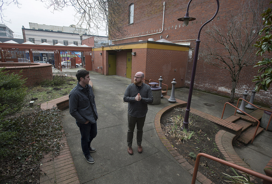 Kylan Johnson, left, and Alex Mickle of Columbia Food Park talk about their vision for the former site of The Urb Garden in downtown Vancouver. The pair aim to place kitchen-equipped shipping containers in the courtyard of the park to serve food.