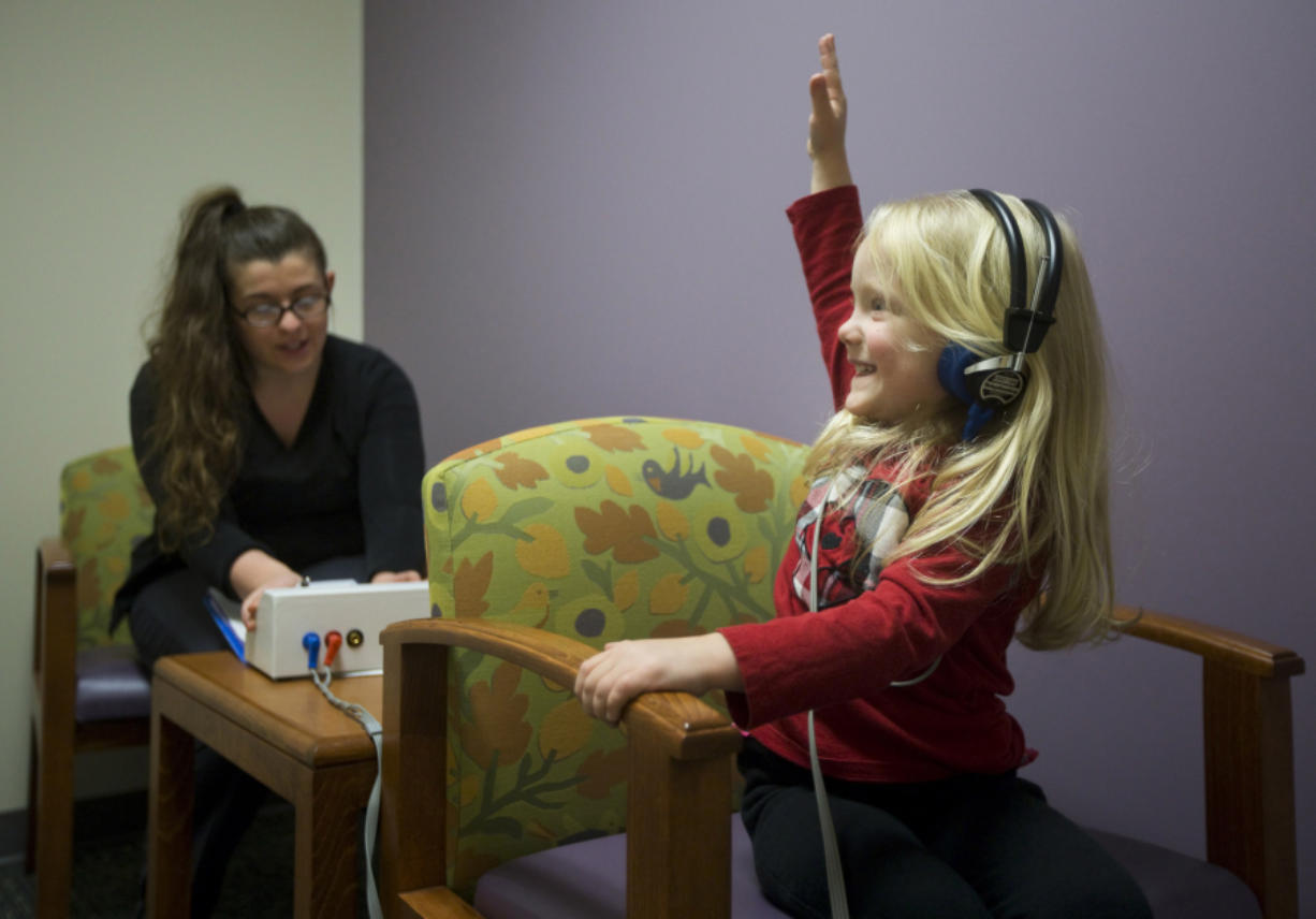 Haddie Brans, 4, gets her hearing tested by certified medical assistant Brandi Lee on Tuesday at the Child &amp; Adolescent Clinic in Salmon Creek. Haddie&#039;s mom, Angela Brans, scheduled the checkup six weeks earlier; Tuesday was the soonest they could get an appointment.