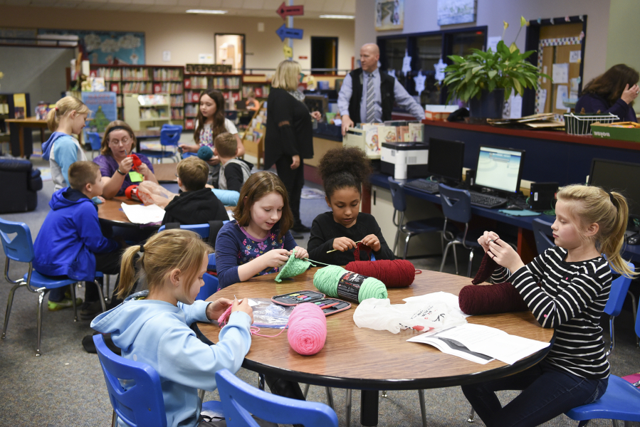Burnt Bridge Creek Elementary School students crochet in the school&#039;s library on Dec. 1 during an after-school program that replaces homework with fun activities for students.
