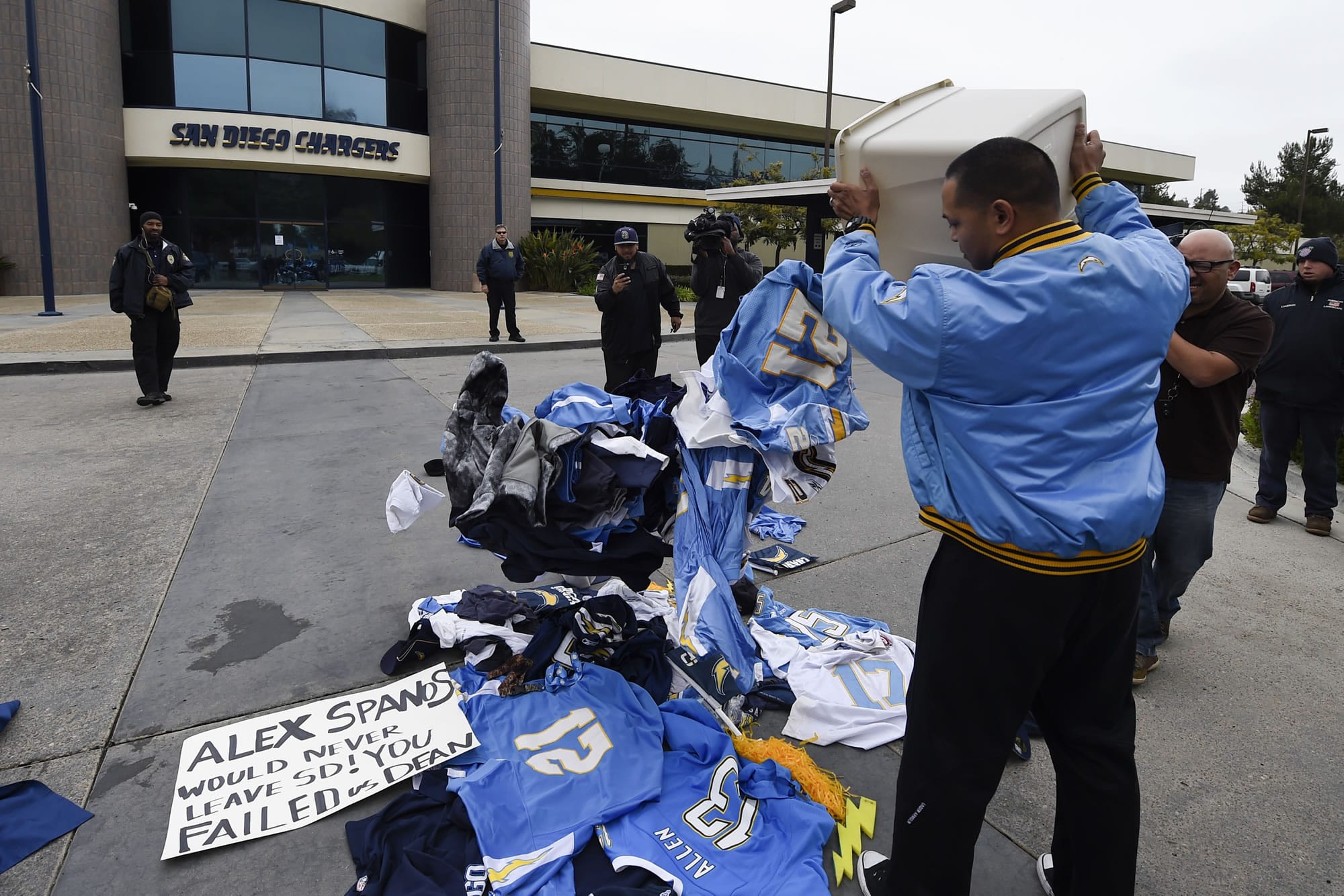 A former Chargers fan dumps memorabilia in front of of the San Diego Chargers headquarters after the team announced that it will move to Los Angeles,  Thursday Jan. 12, 2017, in San Diego.